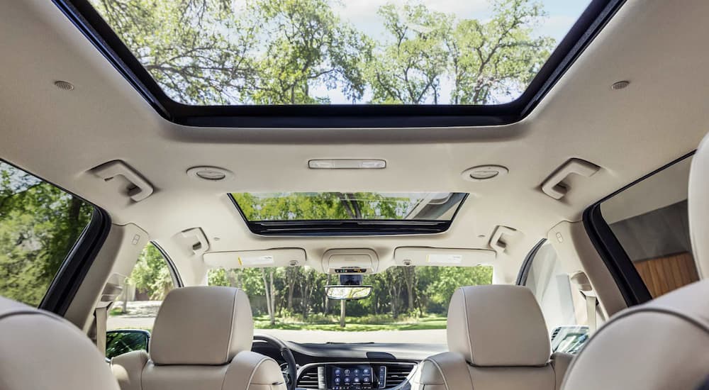 The white interior of a 2023 Buick Enclave is shown.