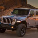 A silver 2022 Jeep Wrangler Rubicon 4xe is shown while driving off-road.