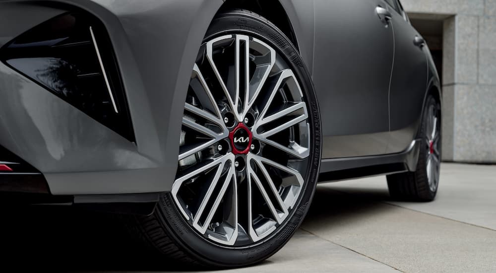 A close up shows the wheel on a grey 2023 Kia Forte GT.