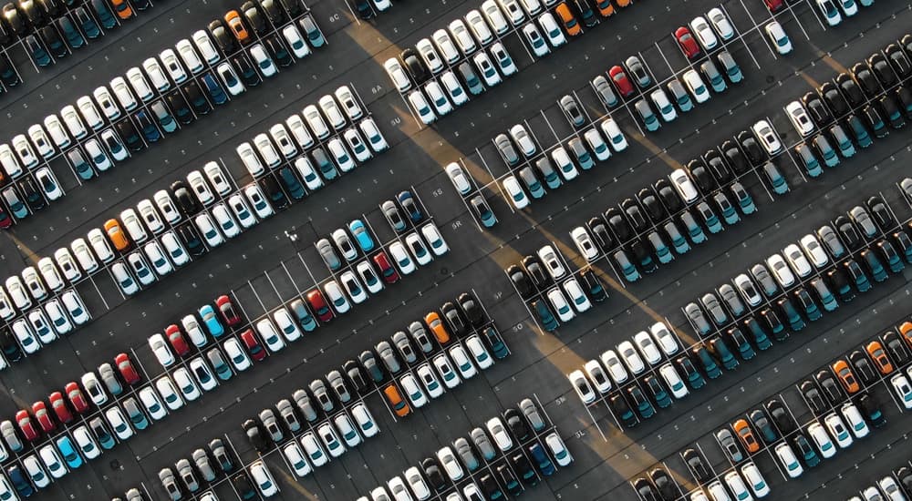 A large car lot is shown from a high angle.