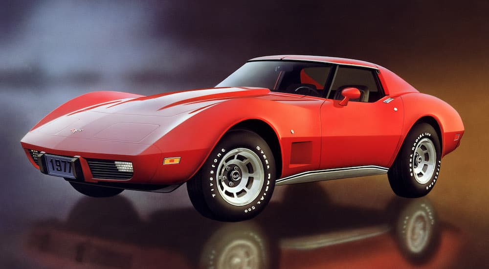 A red 1977 Chevy Corvette is shown from the side.