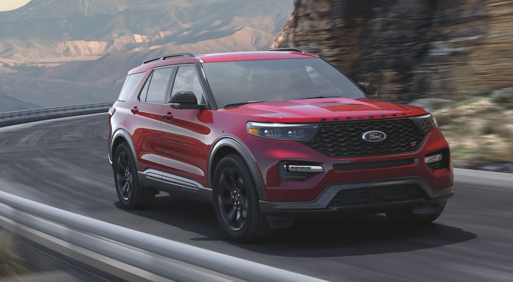 A red 2022 Ford Explorer ST is shown from the front at an angle on a mountain road after leaving a Ford Explorer dealership.
