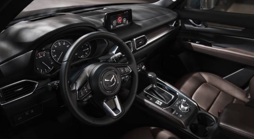 The interior of a 2020 Mazda CX-5 is shown from the driver's side.