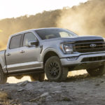 A silver 2023 Ford F-150 Tremor is shown from the front at an angle during a 2022 Ford F-150 vs 2022 Chevy Silverado 1500 comparison.
