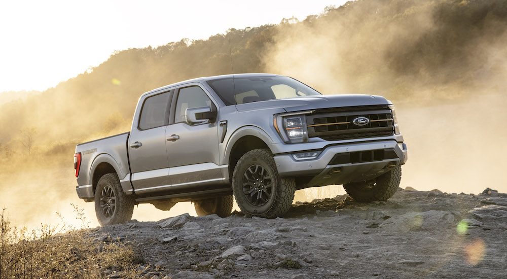 A silver 2023 Ford F-150 Tremor is shown from the front at an angle during a 2022 Ford F-150 vs 2022 Chevy Silverado 1500 comparison.