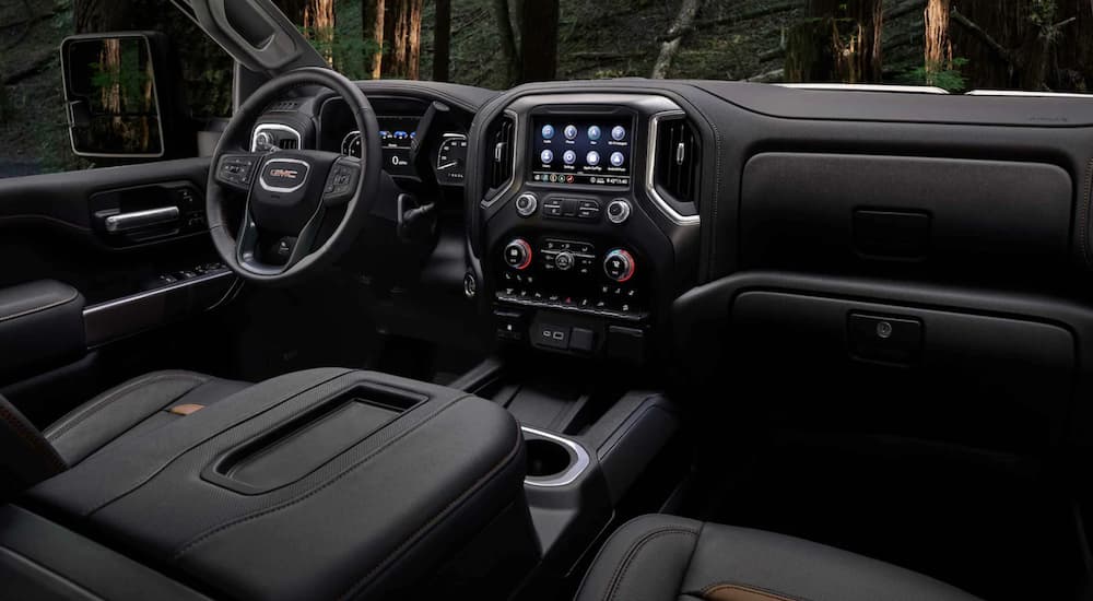 The interior of a 2022 GMC Sierra 2500HD AT4 is viewed from the passenger seat.