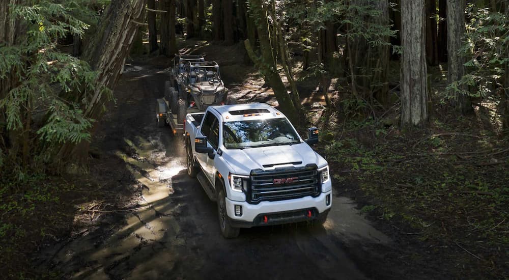 A white 2022 GMC Sierra 2500HD AT4 is shown from the front at a high angle.