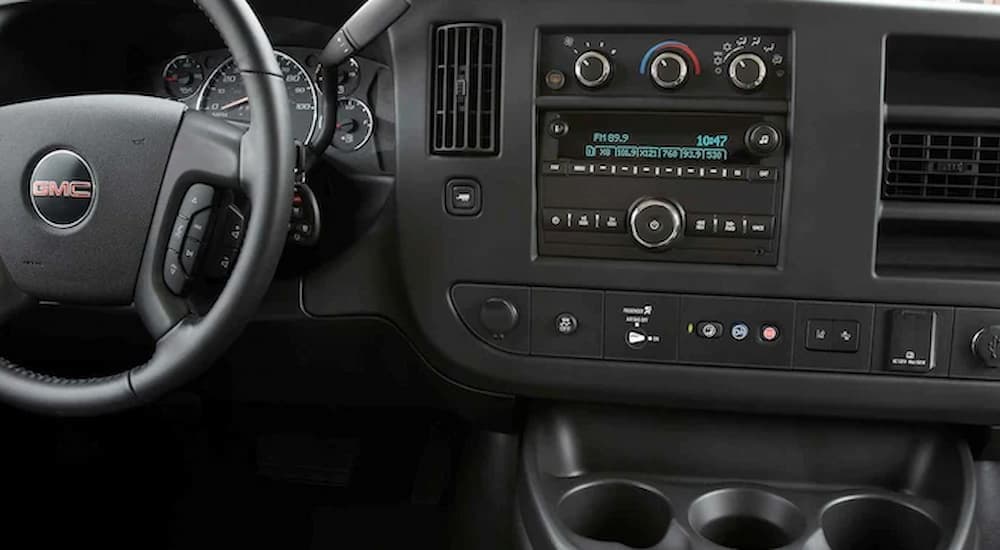 The black dashboard in a 2022 GMC Savana Cutaway 3500 is shown.