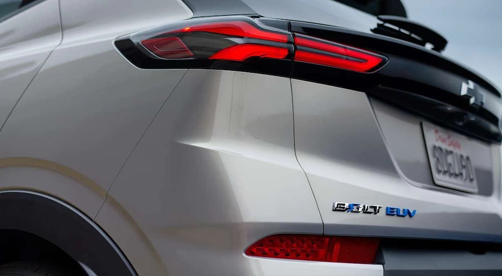 A close up shows the badge and the driver side taillight on a silver 2022 Chevy Bolt EUV.