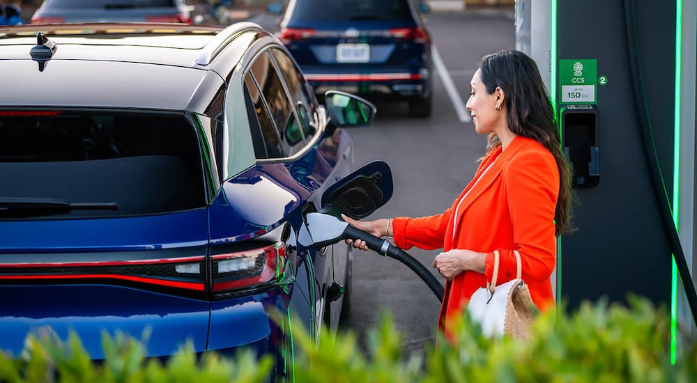 A person is shown charging a blue 2022 Volkswagen ID.4 Pro S.