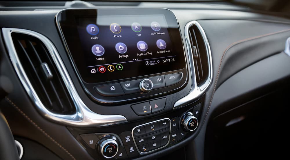 The black interior of a 2023 Chevy Equinox LT shows the infotainment screen.