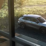 A silver 2023 Honda HR-V is shown outside of a home window.