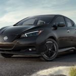 A black 2023 Nissan LEAF is shown parked on a sandy path.