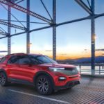 A red 2022 Ford Explorer ST is shown from the front at an angle on a bridge.