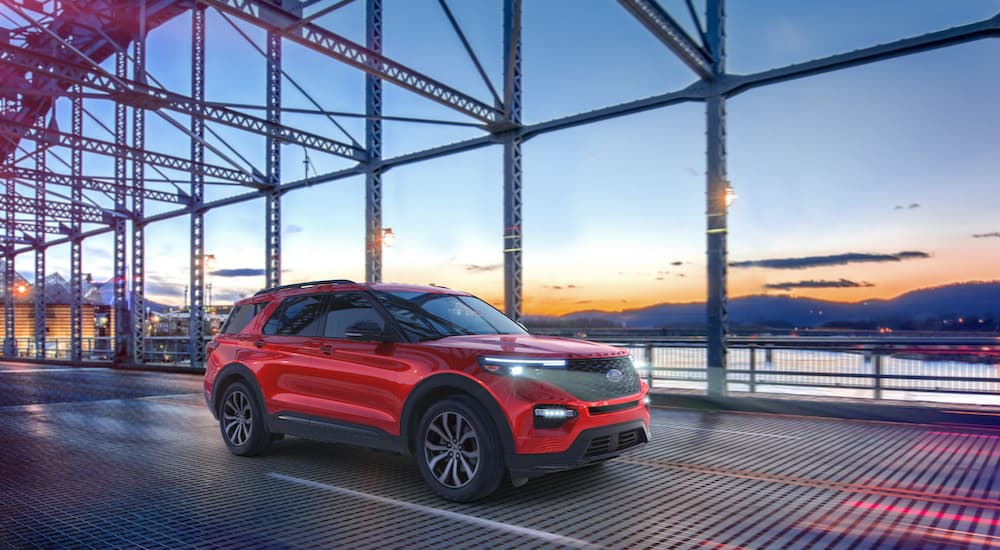 A red 2022 Ford Explorer ST is shown from the front at an angle on a bridge.