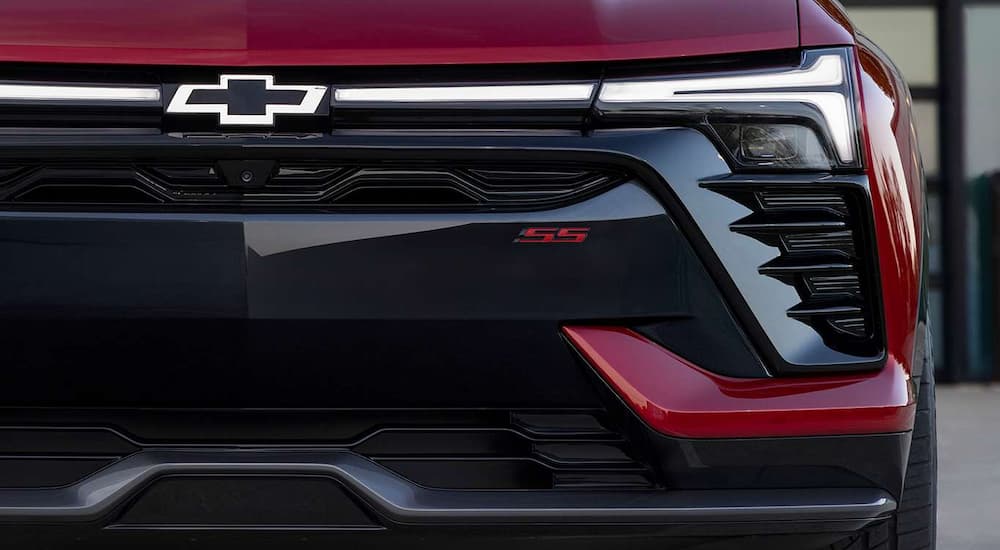 A close up shows the grille and driver side headlight on a red 2024 Chevy Blazer EV SS.