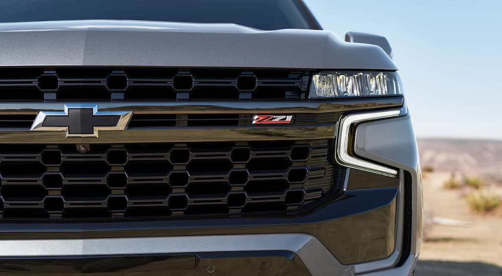 A close up shows the passenger headlight on a silver 2022 Chevy Suburban Z71.