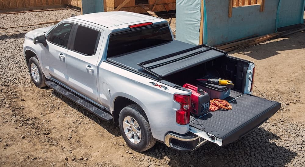 A silver 2022 Chevy Silverado LTD is shown from the rear at a construction site.