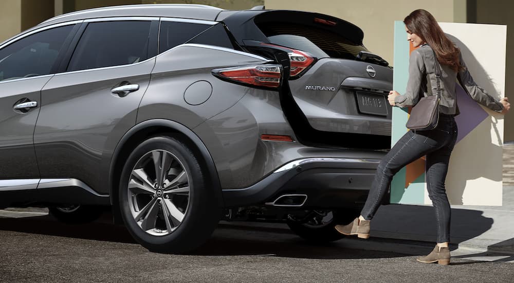 A grey 2023 Nissan Murano is shown with an open trunk.