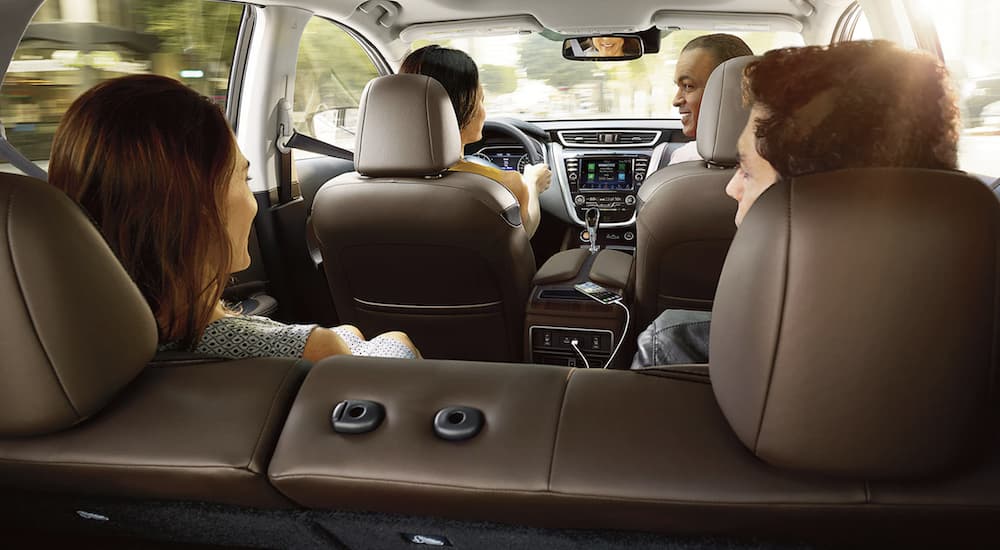 Four people are shown sitting inside a 2023 Nissan Murano.