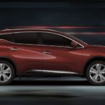 A red 2023 Nissan Murano for sale is shown driving from the side.