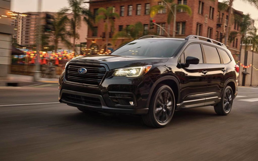 Shown is a black 2022 Subaru Ascent Onyx Edition driving down a city street.