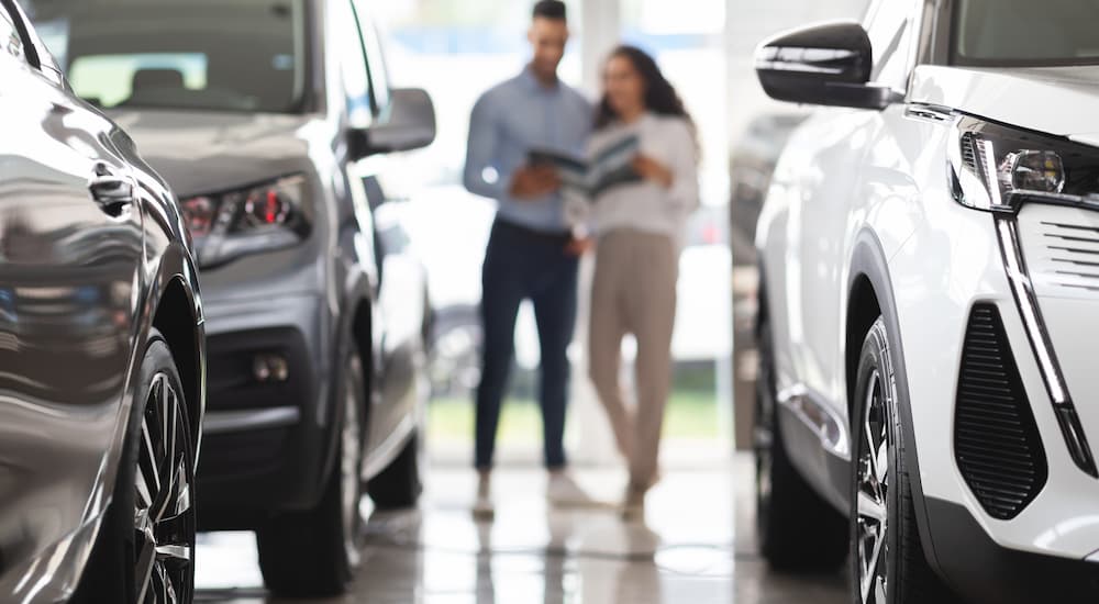 A couple is shown at a car dealership to value their trade in car.