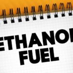 A notebook that says 'ethanol fuel' is shown at a used car dealership.