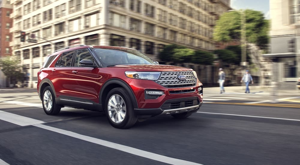 A red 2020 Ford Explorer is shown from the front at an angle after leaving a dealer that advertised having a used Ford Explorer for sale.