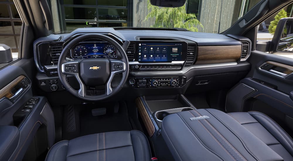 A close up shows the dash and black interior in a 2024 Chevy Silverado 2500HD High Country.