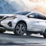 A white 2021 Nissan Murano is shown from the front at an angle on a snowy road after leaving a dealer that had a Nissan Murano for sale.