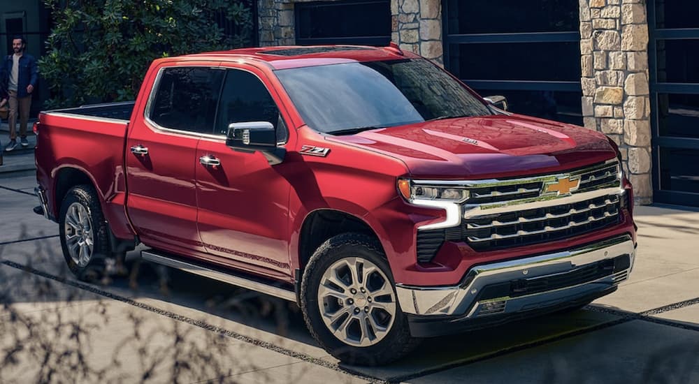 A red 2022 Chevy Silverado 1500 is shown parked in a driveway.