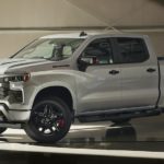 A silver 2023 Chevy Silverado 1500 Redline Edition is shown in a garage after leaving a used Chevy truck dealer near you.