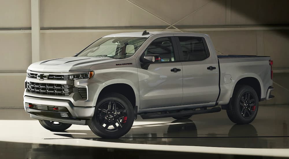A silver 2023 Chevy Silverado 1500 Redline Edition is shown in a garage after leaving a used Chevy truck dealer near you.