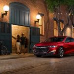 A red 2023 Chevy Malibu RS is shown from the front at an angle.