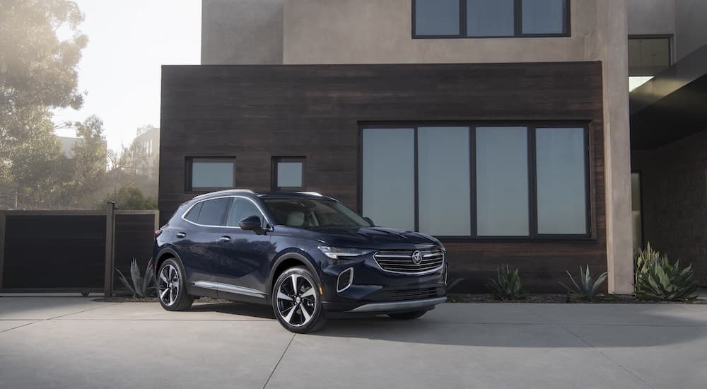 A blue 2023 Buick Envision Avenir is shown from the front at an angle while parked on a driveway.