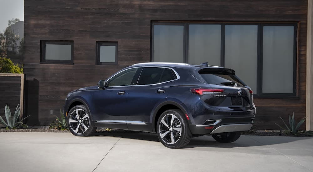 A blue 2023 Buick Envision Avenir is shown from the rear at an angle.