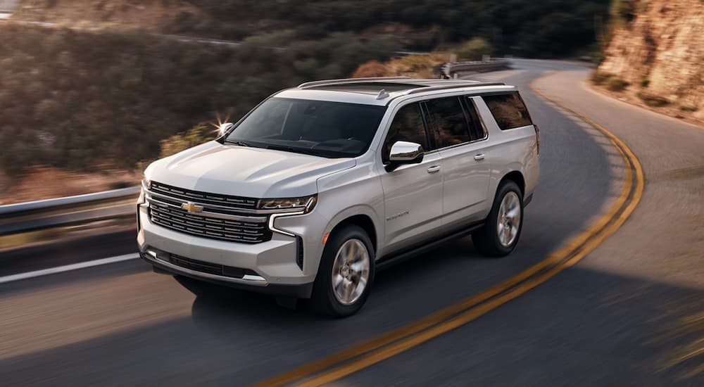 A white 2022 Chevy Suburban is shown from the front at an angle after leaving a used Chevy dealer.