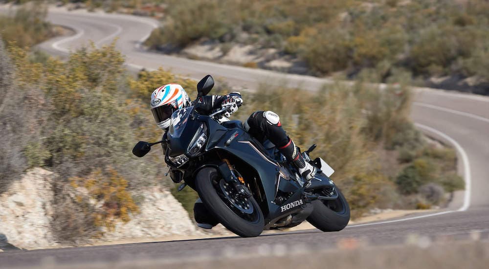 A black 2021 CBR650R is shown from the front while cornering.