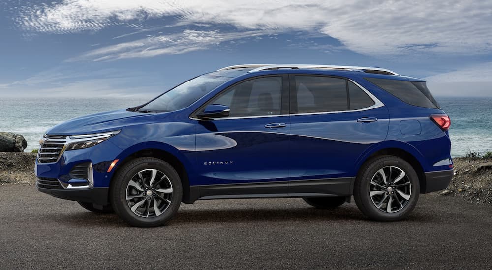 A blue 2023 Chevy Equinox is shown from the side.