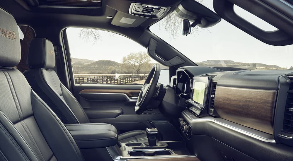 The black interior of a 2023 Chevy Silverado 1500 shows the front seats.