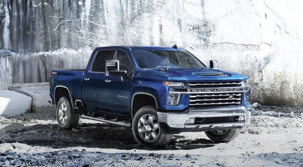 A blue 2023 Chevy Silverado 2500HD is shown from the side.