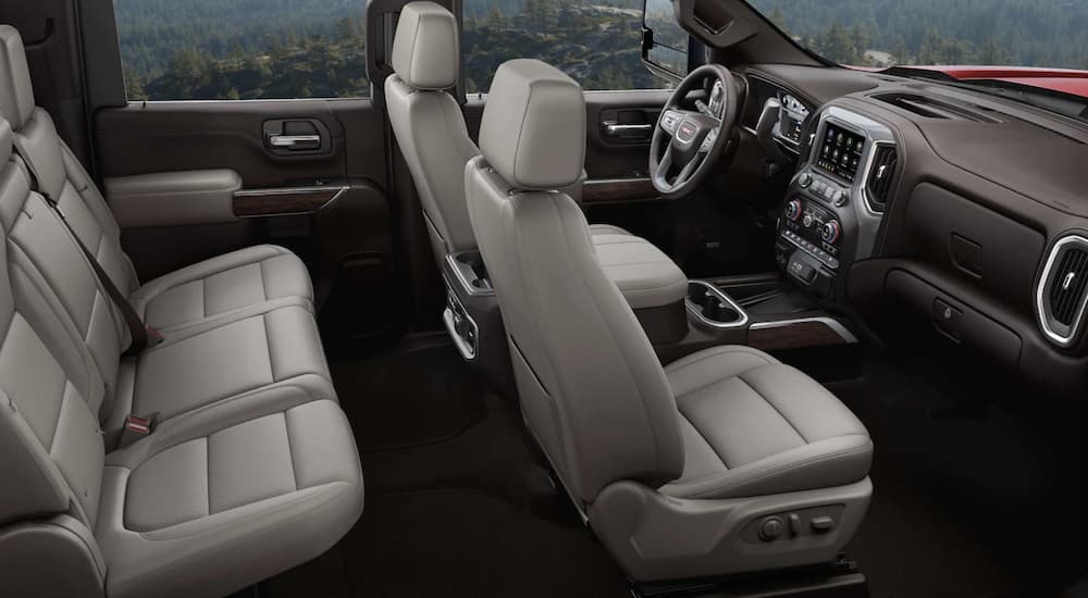 The tan interior of a 2023 GMC Sierra 3500 HD shows two rows of seating.