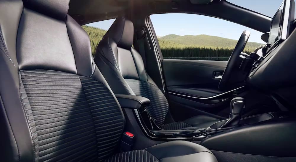 A close up shows the front seats in a 2023 Toyota Corolla XSE.