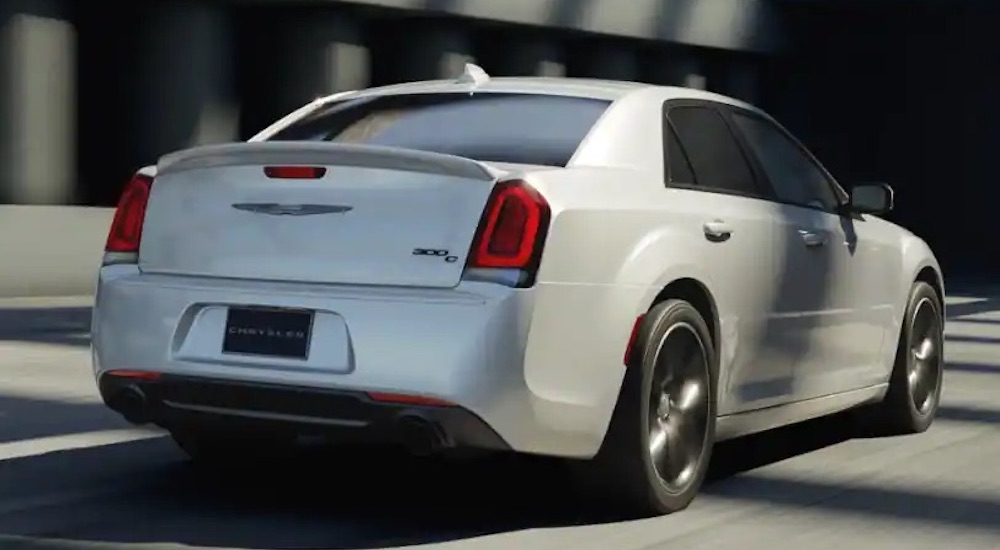 A white 2023 Chrysler 300c is shown from the rear at an angle.