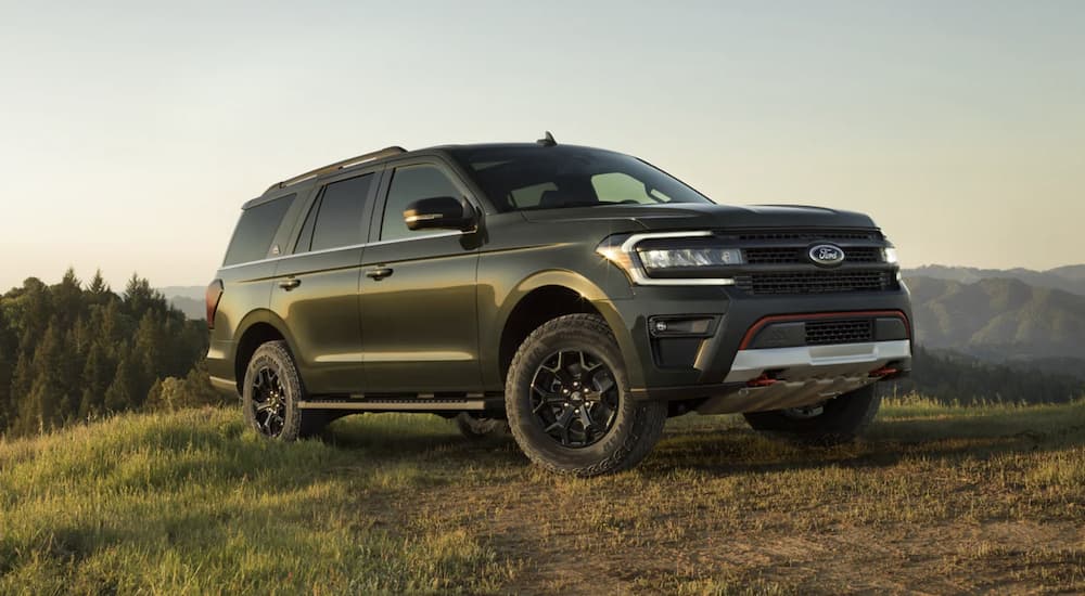 A green 2023 Ford Expedition is shown parked on a grass field.