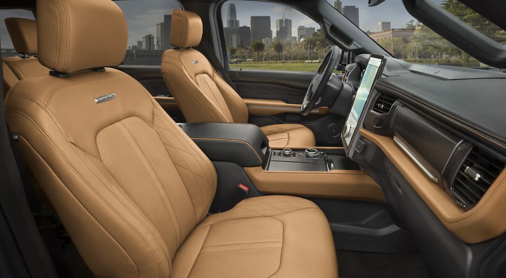 The tan interior of a 2023 Ford Expedition shows the front seats.