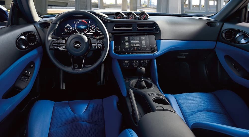 The blue interior of a 2023 Nissan Z is shown from the driver's seat.