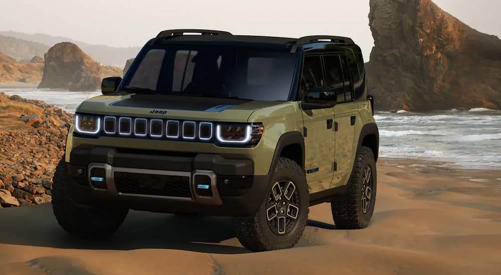 A green 2024 Jeep Recon is shown parked on a beach.