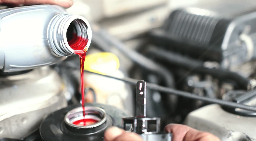 A bottle of brake fluid is shown being poured.
